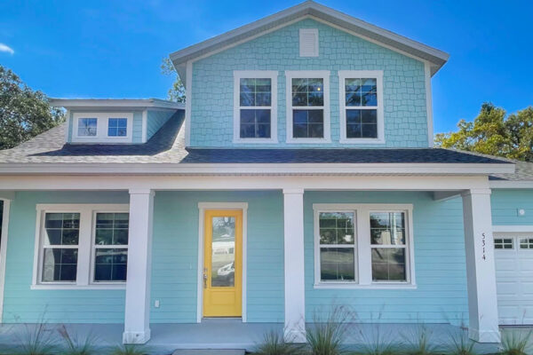 WinWay Homes 2-Story Coastal Home with Light Blue Siding, Yellow Front Door, White Porch Columns & Attached Garage