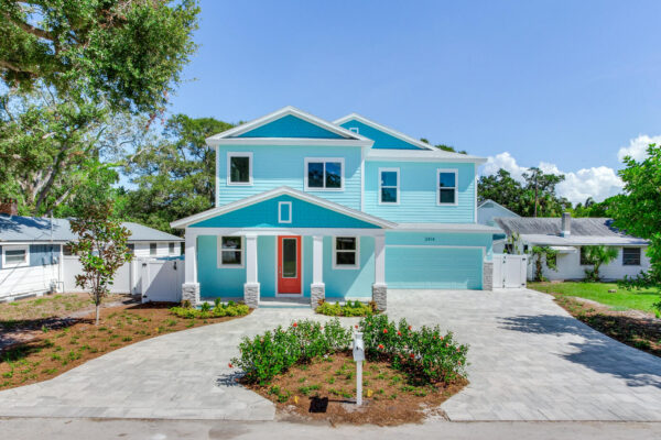 WinWay Homes 2-Story Coastal Home with Aqua Siding, Coral Front Door, White Trim & Attached Garage