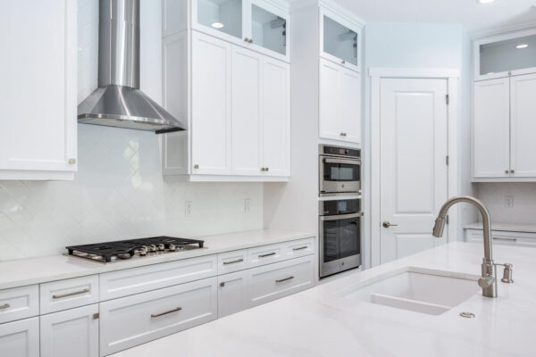 WinWay Homes White Kitchen with Quartz Counters, Stainless Hood, Double Wall Ovens & Large Island Sink