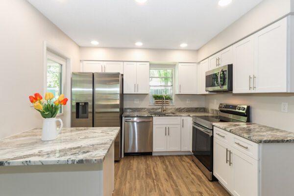 WinWay Homes Modern Kitchen in Off-White with Stainless Steel Appliances, Marble Countertops, Recessed Lighting, and Soft Cream Finishes