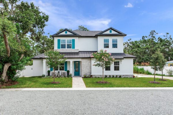 WinWay Homes 2-Story Modern Coastal Home with White Stucco, Teal Shutters, Teal Front Door & Symmetrical Front Elevation