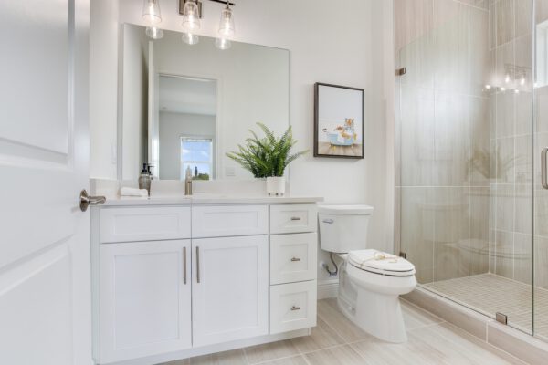 WinWay Homes Sleek Bathroom with Vanity, Framed Mirrors, Glass Shower & Light Tile Finishes
