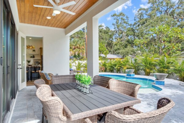 WinWay Homes Covered Patio with Wicker Dining Set, Wood Ceiling, Ceiling Fan & Pool View