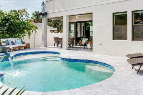 WinWay Homes Backyard Pool with Curved Shape, Water Features, Covered Patio, White Stucco Exterior & Paver Decking