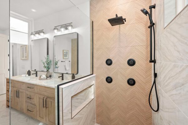 WinWay Homes Primary Luxurious Bathroom with Wood Double Vanity, Framed Mirrors, Glass Shower & Light Tile Finishes