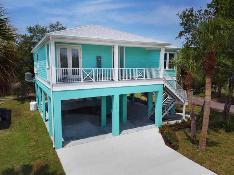 Elevated Custom Home in Blue-Green with White Trim & Palm Trees | WinWay Homes Pinellas County