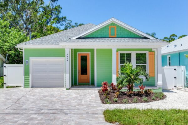 WinWay Homes 1-Story Coastal Cottage with Green Siding, Orange Front Door, White Trim & Covered Porch