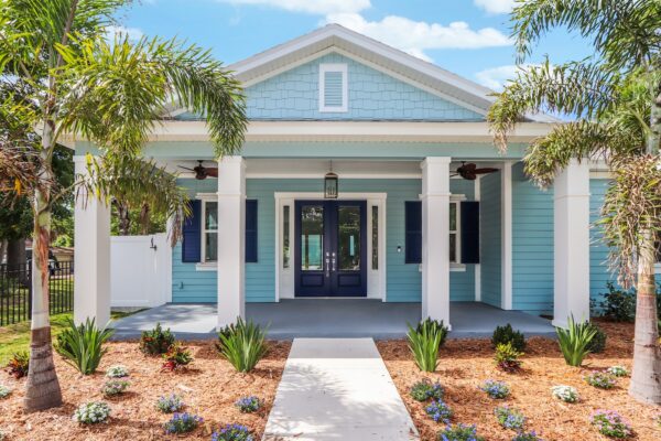 WinWay Homes Costal Cottage in Light Blue Siding, White Trim, Blue Door and Shutters with New Landscaping