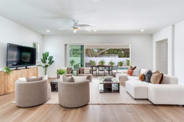 WinWay Homes Living Room with picture window, light wood-look flooring, neutral seating, ceiling fan & open modern layout