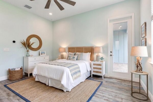 WinWay Homes Bedroom in Pale Green and White with Ceiling Fan, Bedding in Neutral Tones and Glass Patio Door