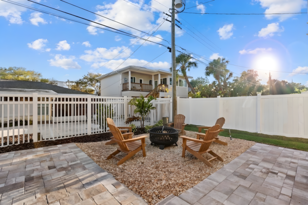 WinWay Homes Backyard Fire Pit Patio with Adirondack Chairs, Paver Border, White Privacy Fence & Gravel Center