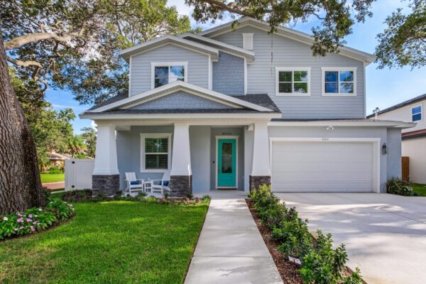 New 2-Story Pale Gray Home Exterior by WinWay Homes with Covered Porch, Aqua Door, White Columns and Tone Accents
