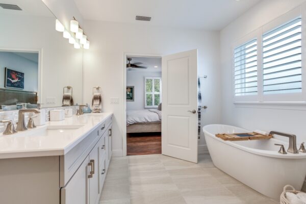 WinWay Homes Spa Bathroom with Freestanding Tub, Walk-In Shower, White Vanity & Light Tile Flooring