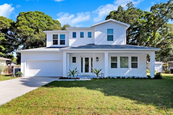 WinWay Homes 2-Story White Coastal Home with White Siding, Covered Porch, Black Front Door & Attached Garage