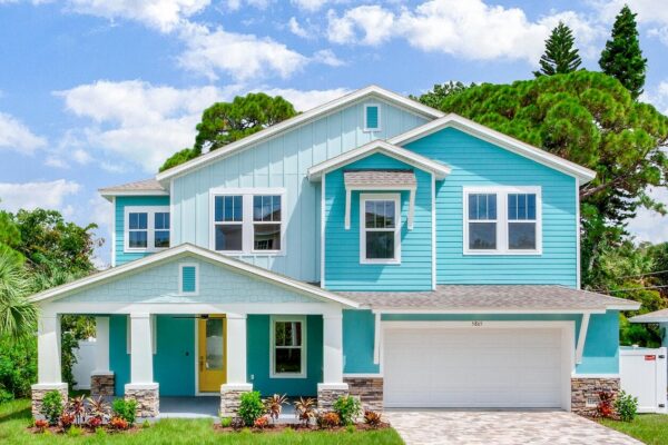 WinWay Homes 2-Story Coastal Home with Aqua Siding, White Columns, Covered Porch & Attached Garage