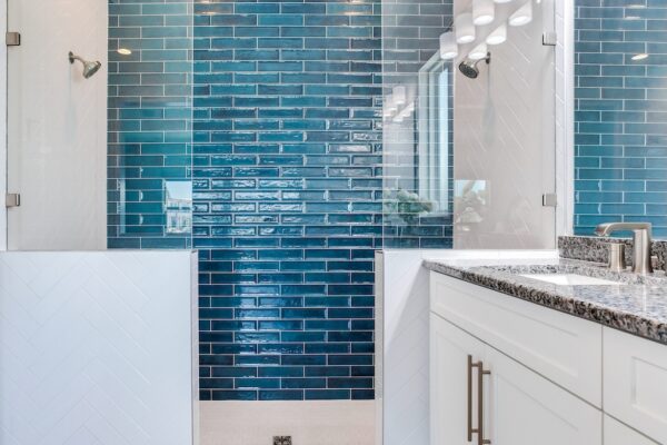 WinWay Homes Spa Bathroom With Blue Glass Tile Shower Wall, Dual Shower Heads, White Vanity, Granite Countertop & Glass Shower Enclosure