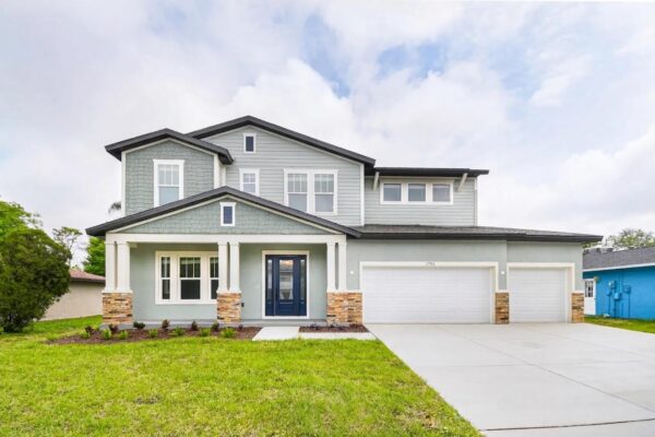 WinWay Homes 2-Story Coastal Home With Gray Siding, Blue Front Door, Stone Accents, Covered Front Porch & 3-Car Garage