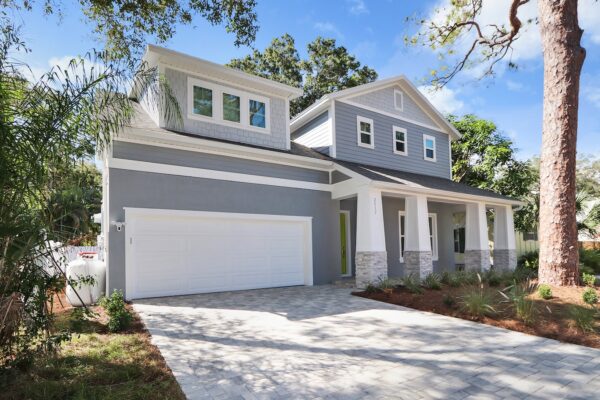 WinWay Homes 2-Story Coastal Home with Gray Siding, White Trim, Covered Front Porch, Attached Garage & Wide Concrete Driveway