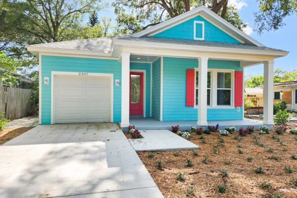 WinWay Homes 1-Story Coastal Cottage with Turquoise Siding, Coral Shutters, Covered Front Porch & Attached Garage