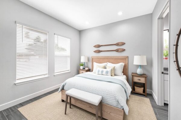 WinWay Homes Primary Bedroom with Pale Gray Walls, Wooden Headboard, Light Flooring & Soft Coastal Styling