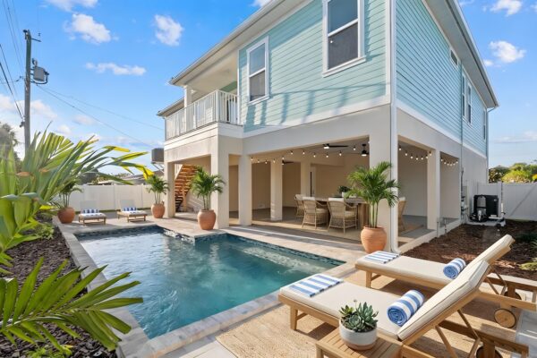 WinWay Homes Elevated Coastal Home Backyard with Pool, Covered Lounge, Upper Balcony & Tropical Styling