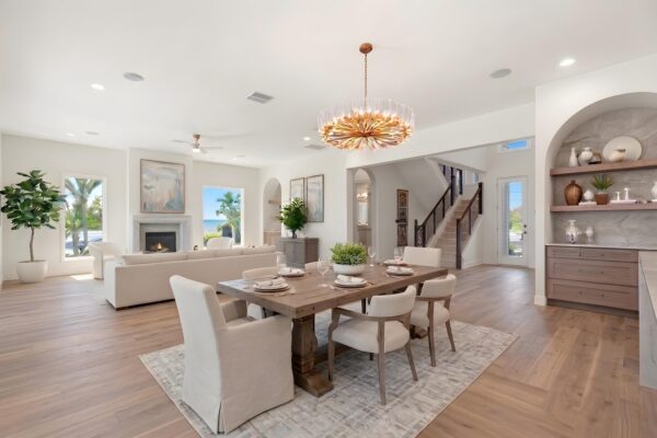 WinWay Homes Living and Dining Area with Open Kitchen, Neutral Furnishings, Wood-Look Flooring & Open Layout and Dramatic Lighting