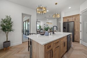 Custom Kitchen with Island in Natural Wood and Light Marble with Statement Lighting Fixtures by WinWay Homes
