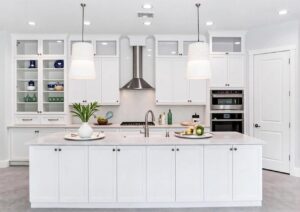 Beautifully Designed Kitchen with White Custom Cabinetry and Statement Lighting
