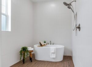 WinWay Homes Spa Style Master Bath Wet Room in White with Freestanding Tub and Wood Style Flooring