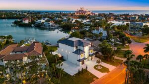 Aerial View of Large Modern Coastal Home in White with Black Roofing with a Pool by WinWay Homes in St. Petersburg, Florida